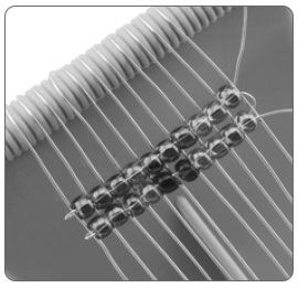 Two rows of beads on a loom